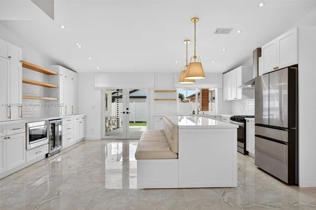 a kitchen with stainless steel appliances granite countertop a stove oven and a refrigerator