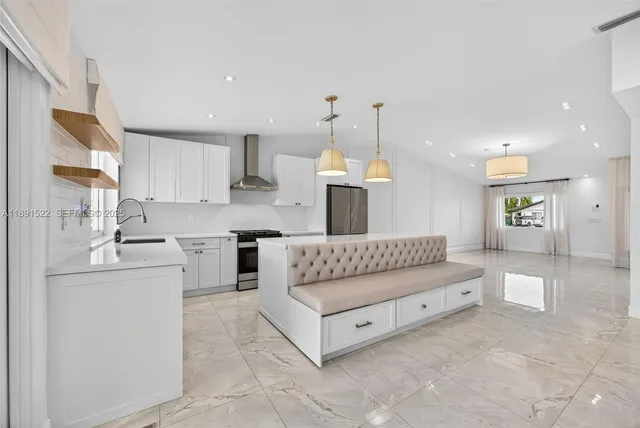 a living room with furniture and kitchen view