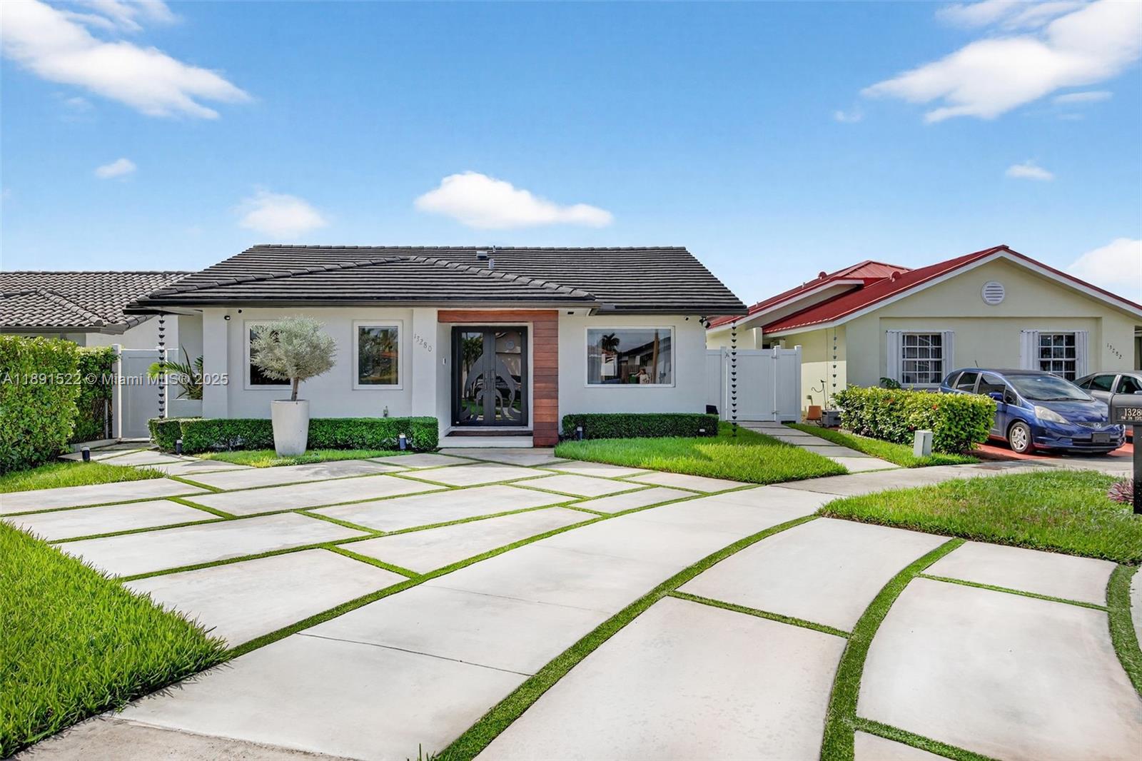 13280 Southwest 39th Terrace Miami, FL 33175 - Photo 3 of 57 a front view of a house with a yard and garage