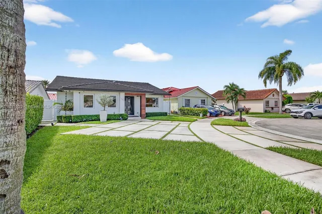 a view of a house with swimming pool and a yard