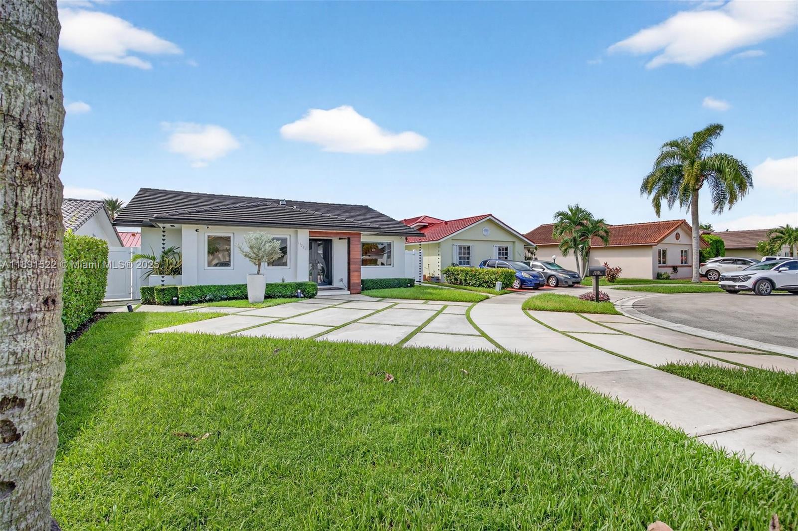 13280 Southwest 39th Terrace Miami, FL 33175 - Photo 4 of 57 a view of a house with swimming pool and a yard