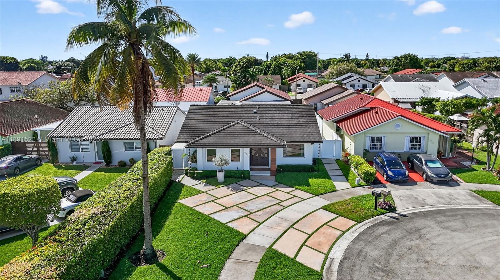 13280 Southwest 39th Terrace Miami, FL 33175 - Photo 46 of 57 a front view of a house with a yard and potted plants
