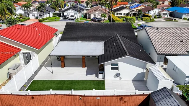 an aerial view of residential houses with outdoor space