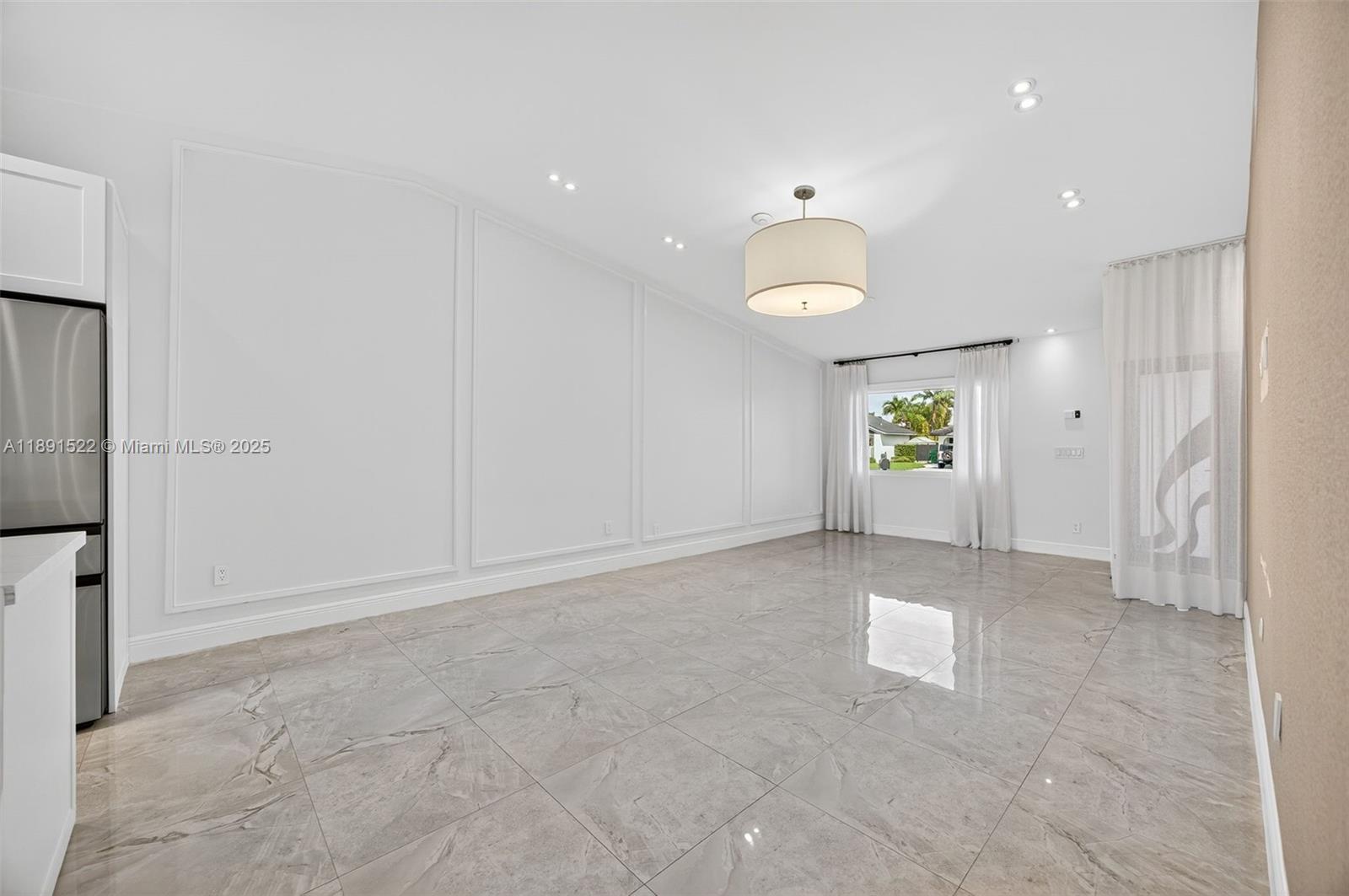 13280 Southwest 39th Terrace Miami, FL 33175 - Photo 8 of 57 an empty room with windows and refrigerator