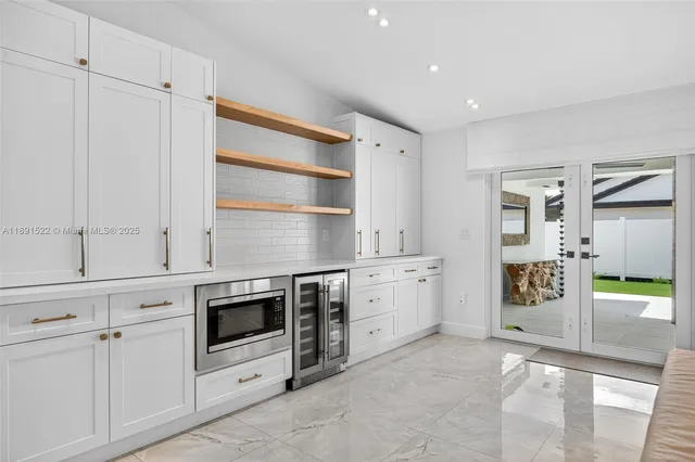 a kitchen with granite countertop cabinets and appliances