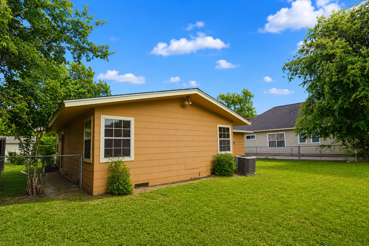 1508 Walnut Street Georgetown, TX 78626 - Photo 28 of 37 A vibrant lawn and mature trees frame this delightful dwelling, offering a serene outdoor retreat.