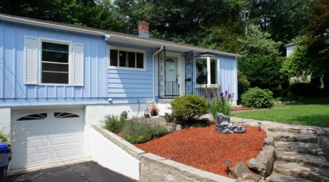 a view of house with backyard outdoor seating and green space