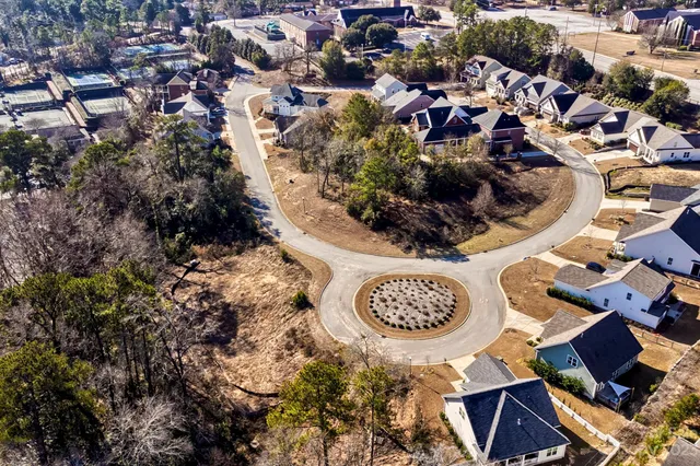 an aerial view of residential house with outdoor space and trees all around