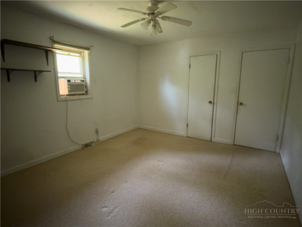 1205 Bamboo Road Boone, NC 28607 - Photo 8 of 17 an empty room with a ceiling fan and window
