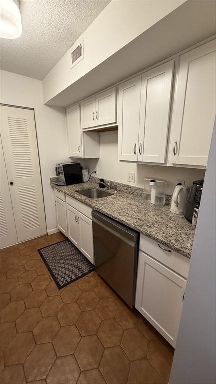 150 Lewis Street, Unit 302 Lynn, MA 01902 - Photo 3 of 18 a kitchen with a sink stove and cabinets