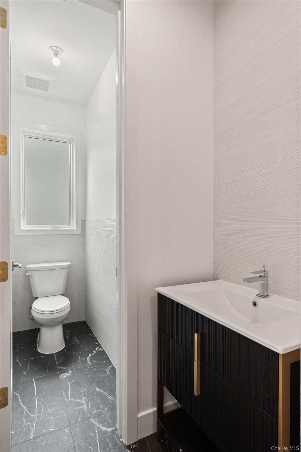 23 Singer Avenue, Unit 211 Spring Valley, NY 10977 - Photo 11 of 45 a bathroom with a sink and a toilet