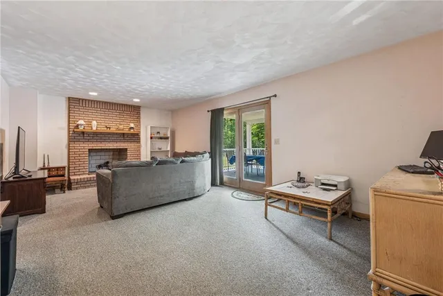 a kitchen with stainless steel appliances granite countertop a stove a refrigerator a sink a dining table and chairs with wooden floor