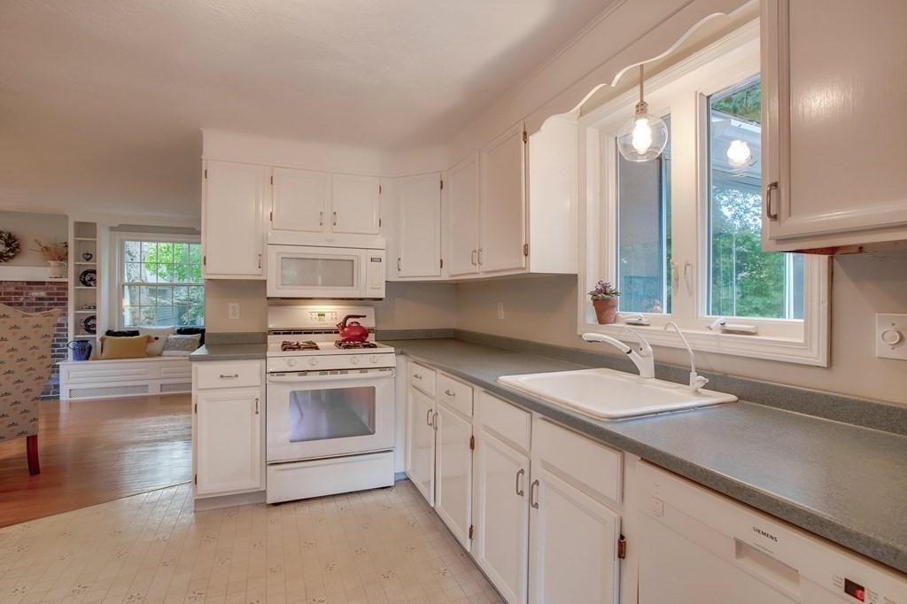 6 Peach Tree Path Andover, MA 01810 - Photo 11 of 33 a kitchen with granite countertop white cabinets and white appliances