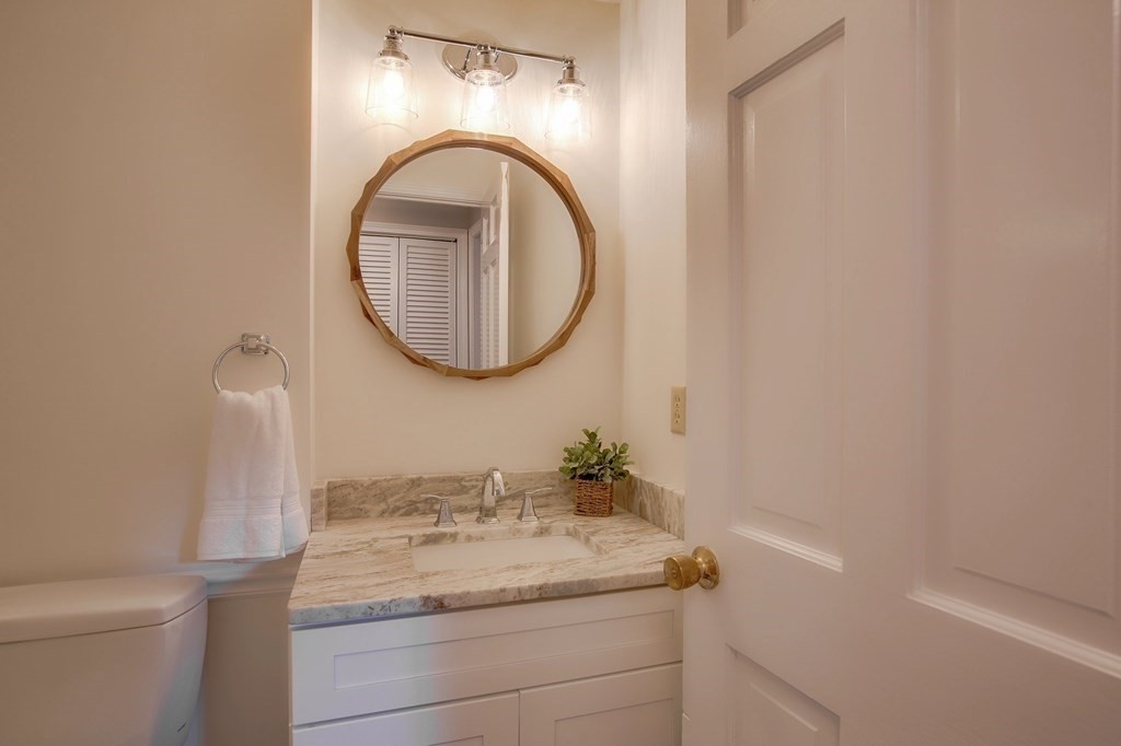 6 Peach Tree Path Andover, MA 01810 - Photo 14 of 33 a bathroom with a granite countertop sink a toilet and a mirror