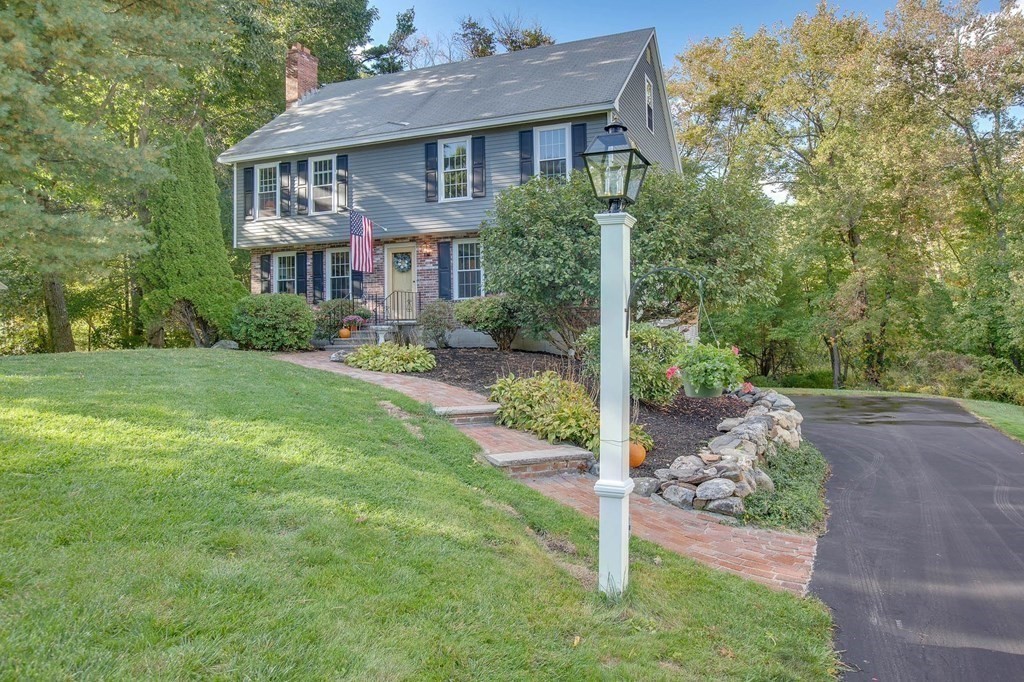 6 Peach Tree Path Andover, MA 01810 - Photo 2 of 33 a front view of a house with a yard and garage