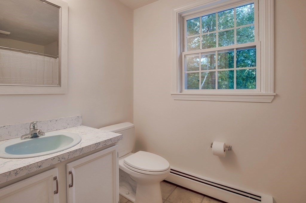 6 Peach Tree Path Andover, MA 01810 - Photo 21 of 33 a bathroom with a sink a toilet and a mirror