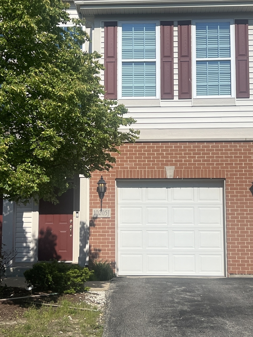 10205 Mulberry Lane, Unit J Bridgeview, IL 60455 - Photo 1 of 12 a front view of a house with a garage