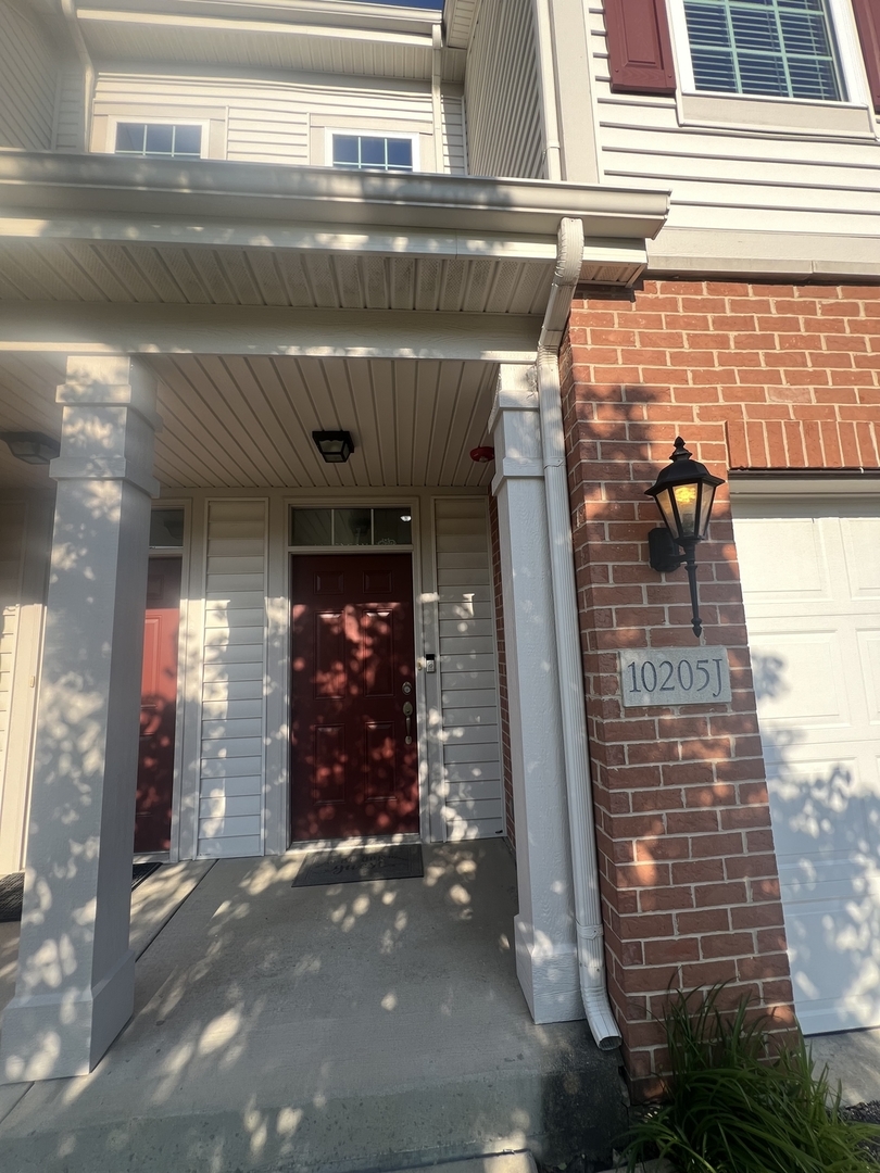 10205 Mulberry Lane, Unit J Bridgeview, IL 60455 - Photo 12 of 12 a front view of a building with glass door