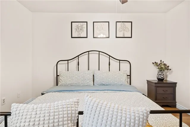 a bedroom with a bed and a potted plant