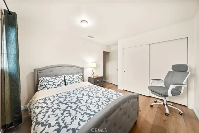 a bedroom with a bed and a chair