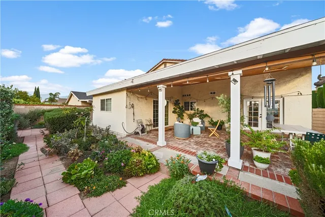 a view of a patio with table and chairs potted plants