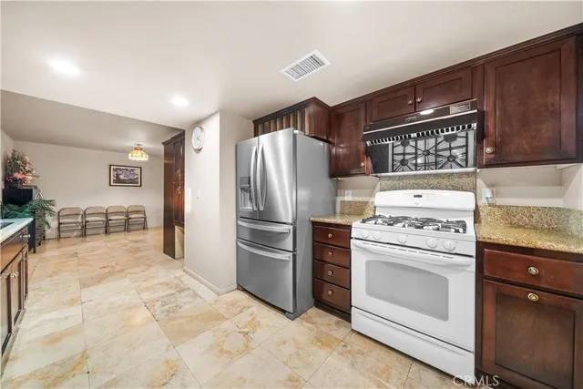 a kitchen with refrigerator and cabinets