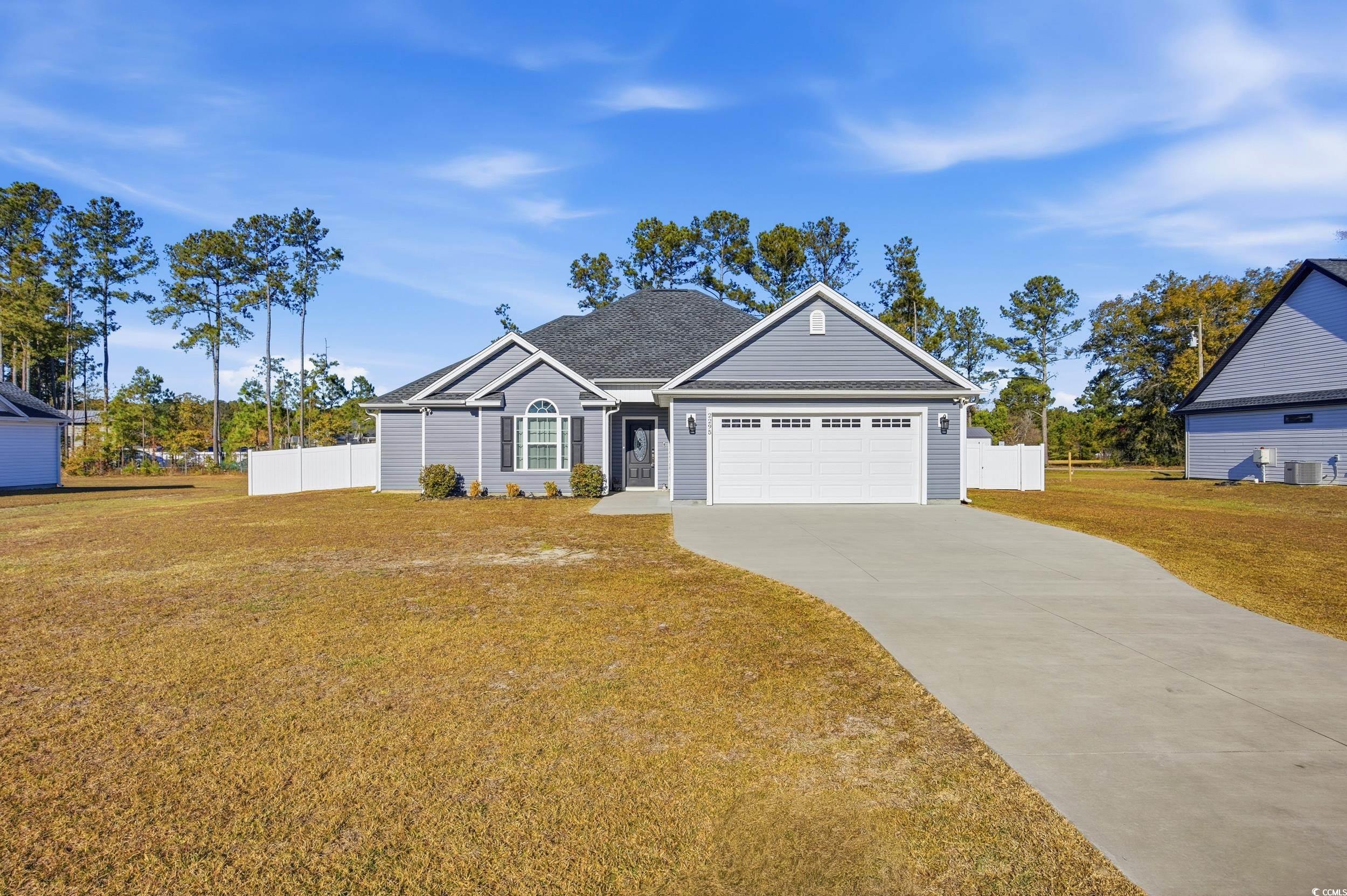 View of front facade with concrete driveway and an attached garage