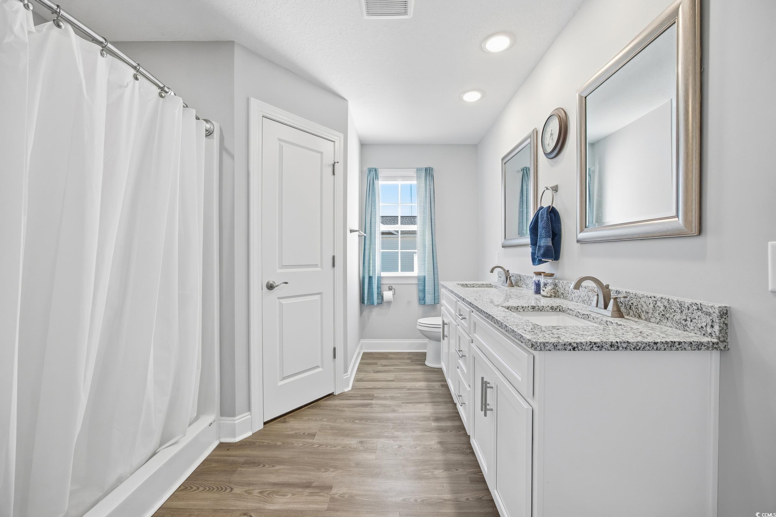 2295 Vaught Road Galivants Ferry, SC 29544 - Photo 12 of 26 Bathroom with a shower with curtain, double vanity, light wood-type flooring, and recessed lighting