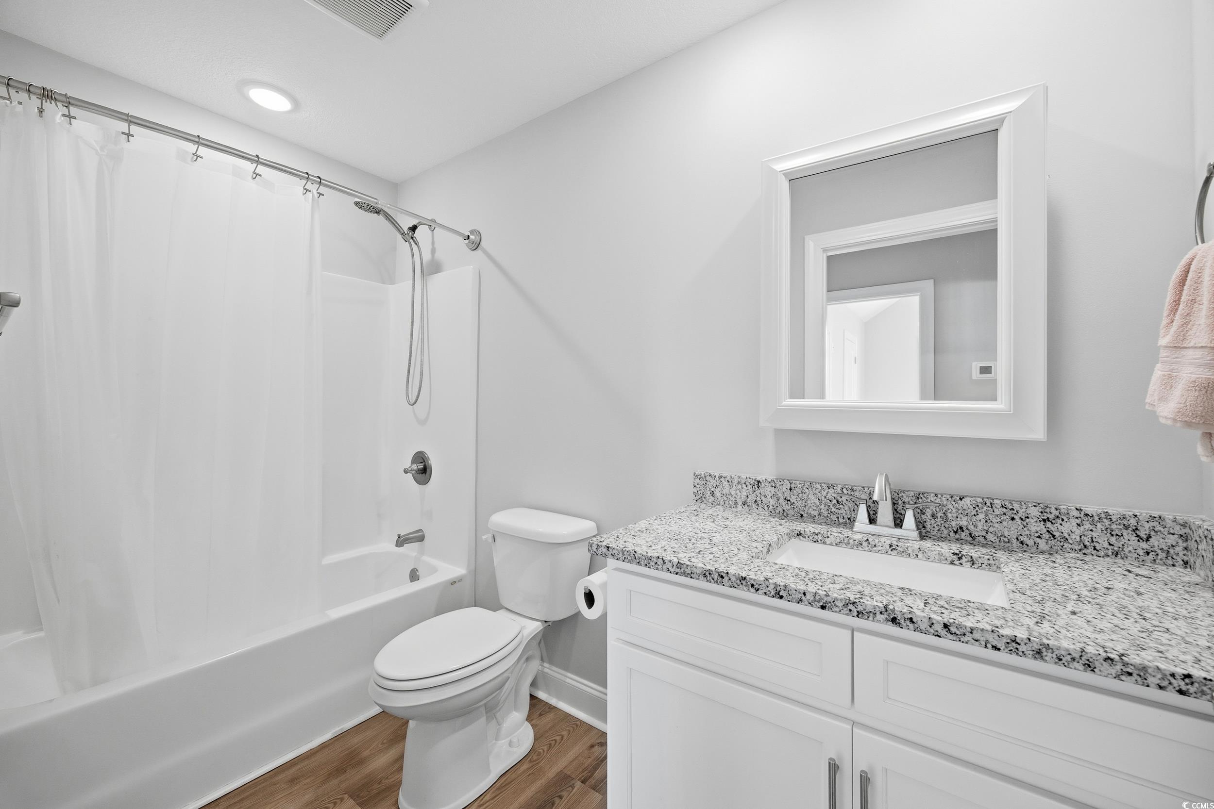 2295 Vaught Road Galivants Ferry, SC 29544 - Photo 15 of 26 Full bathroom with shower / bath combination with curtain, wood finished floors, and vanity