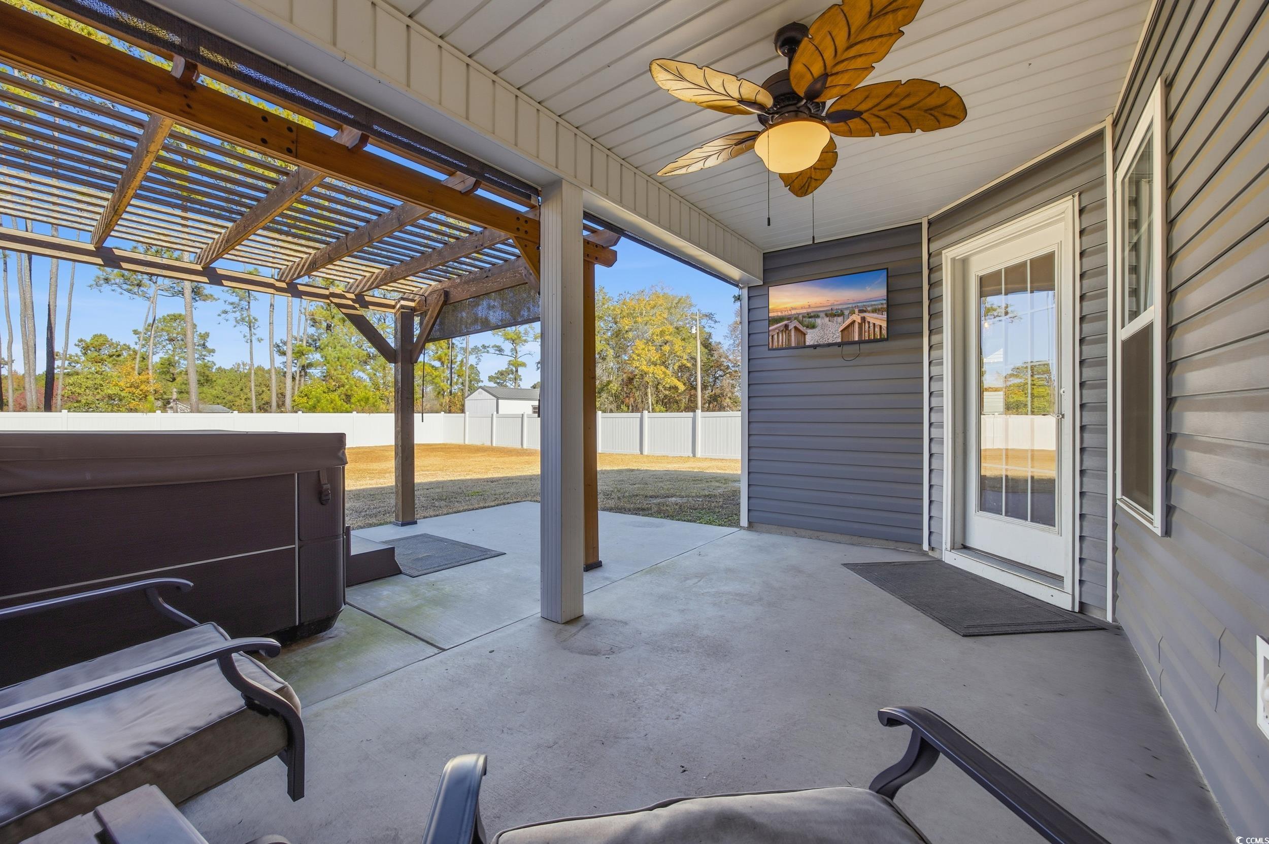 2295 Vaught Road Galivants Ferry, SC 29544 - Photo 17 of 26 Fenced backyard featuring a patio area, a pergola, ceiling fan, and a hot tub
