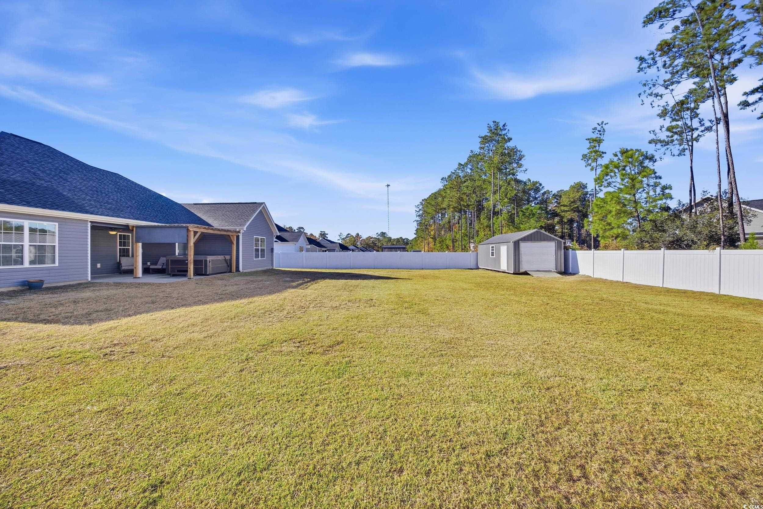 2295 Vaught Road Galivants Ferry, SC 29544 - Photo 21 of 26 Fenced backyard featuring a patio area and an outbuilding