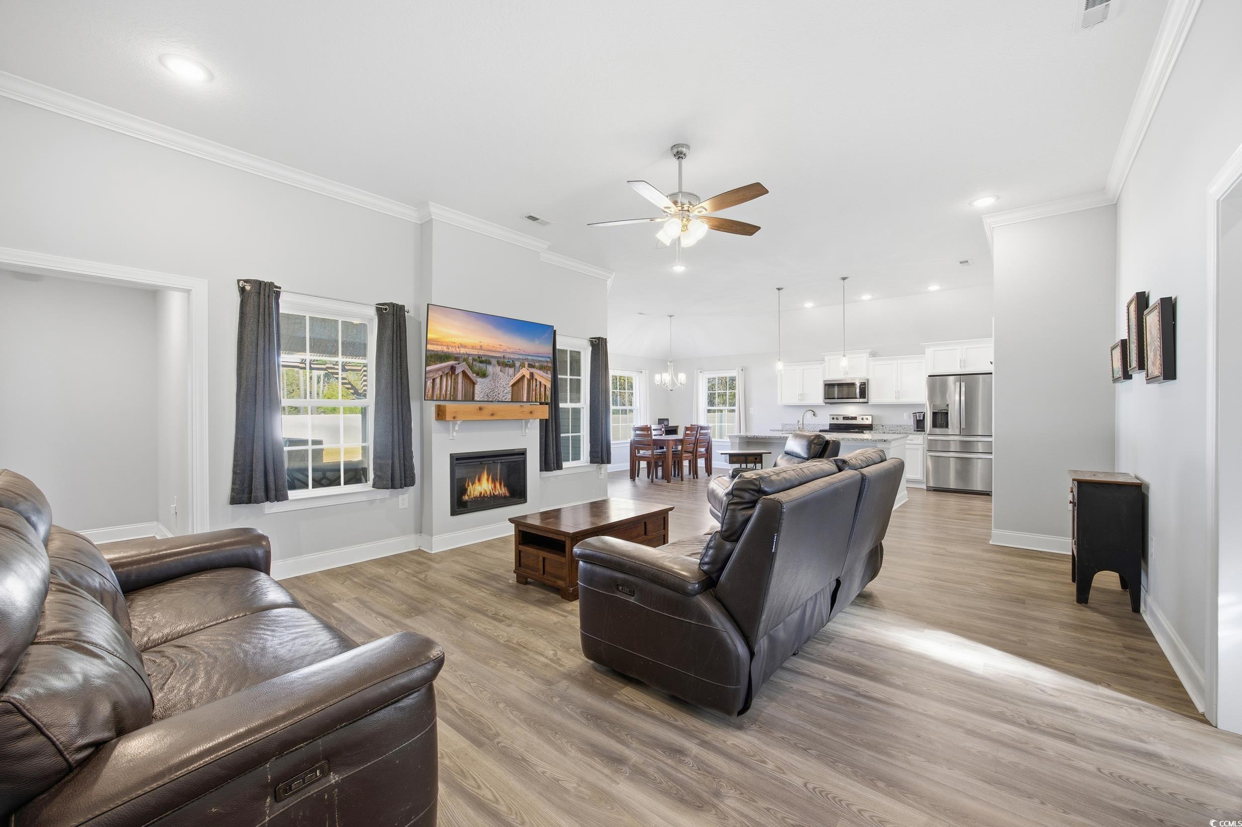 2295 Vaught Road Galivants Ferry, SC 29544 - Photo 5 of 26 Living room with crown molding, plenty of natural light, light wood finished floors, recessed lighting, and ceiling fan