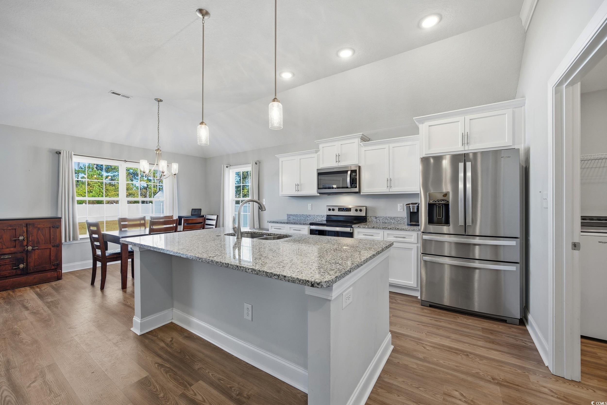 2295 Vaught Road Galivants Ferry, SC 29544 - Photo 7 of 26 Kitchen with stainless steel appliances, lofted ceiling, light stone counters, white cabinets, and a chandelier