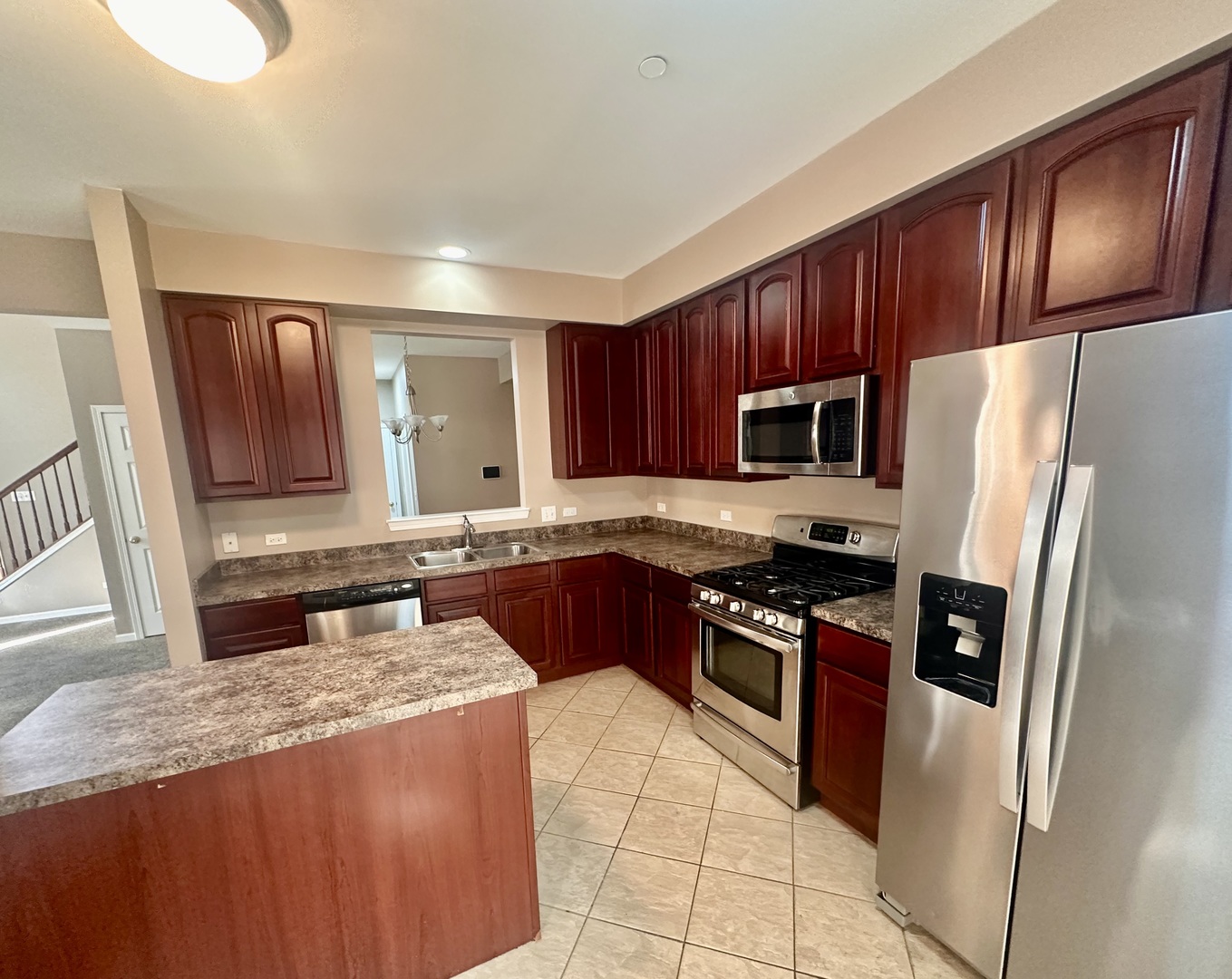 1850 Candlelight Circle Montgomery, IL 60538 - Photo 11 of 29 a kitchen with granite countertop stainless steel appliances a stove sink and microwave