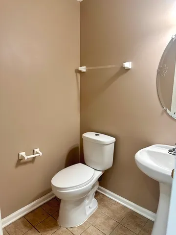 a white toilet sitting next to a bathroom sink