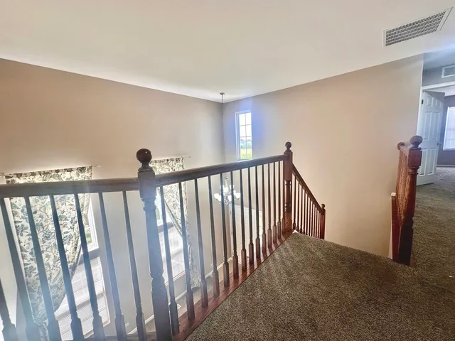 a view of staircase with rug floor