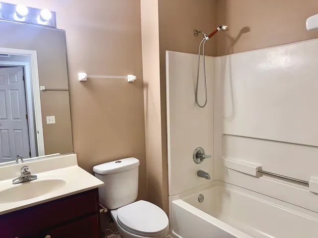 a bathroom with a toilet sink and shower