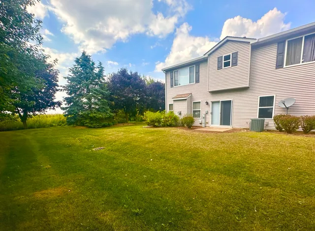 a front view of house with yard and trees
