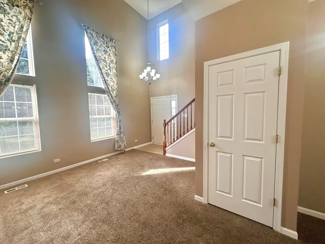 an empty room with windows and entryway