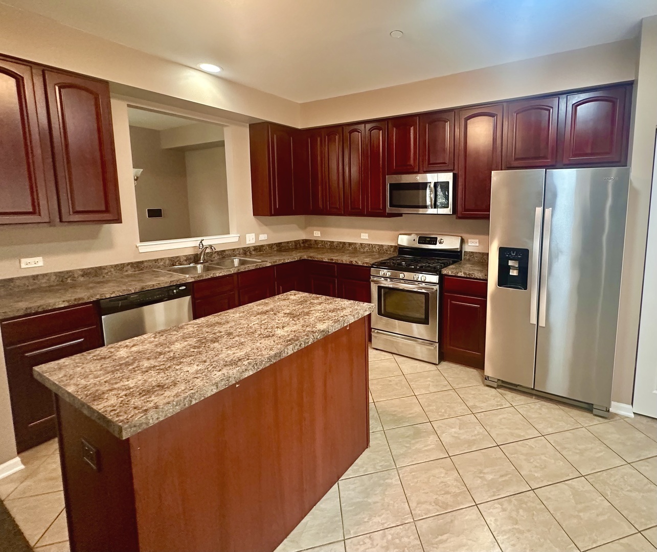 1850 Candlelight Circle Montgomery, IL 60538 - Photo 10 of 29 a kitchen with stainless steel appliances granite countertop a stove refrigerator sink and microwave