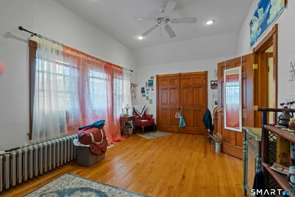 a bedroom with furniture and large window