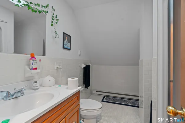 a bathroom with a sink toilet and a mirror