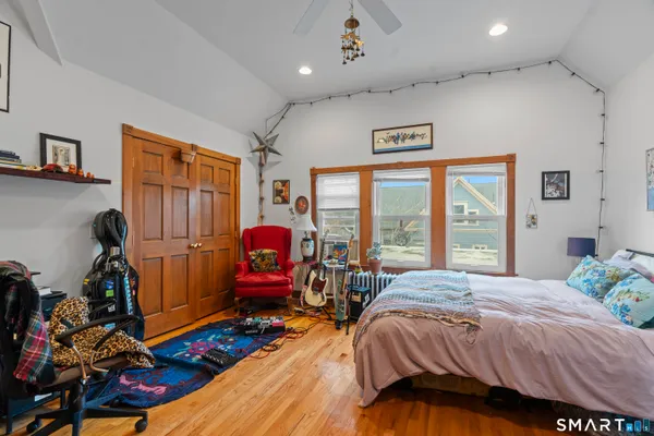 a bedroom with a bed and a large window