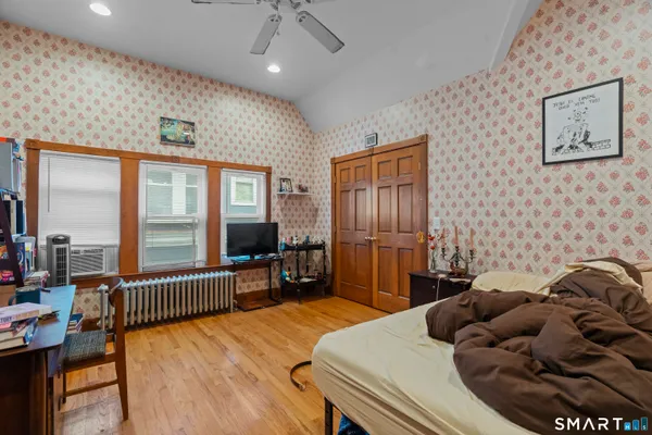 a bedroom with furniture and a large window