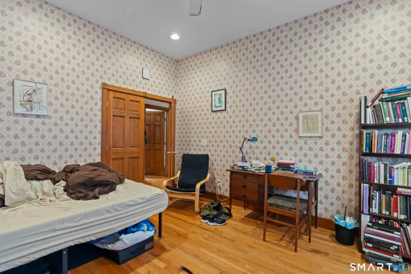 a view of a workspace with furniture and a bookshelf