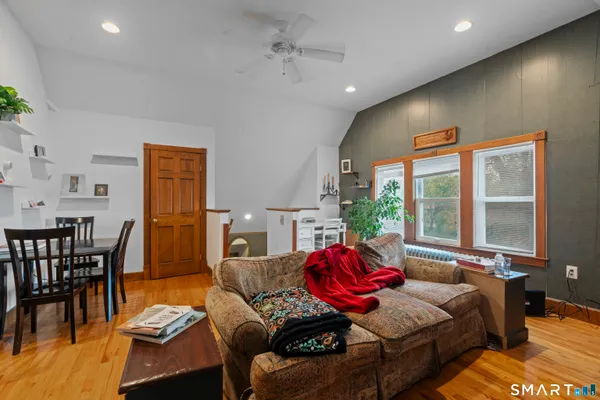 a living room with furniture and large windows