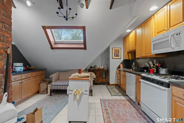 a kitchen with stainless steel appliances a stove a sink and a refrigerator