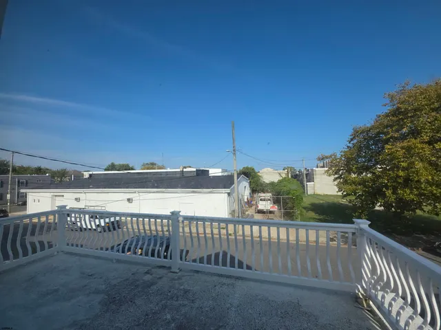 a view of a balcony with yard