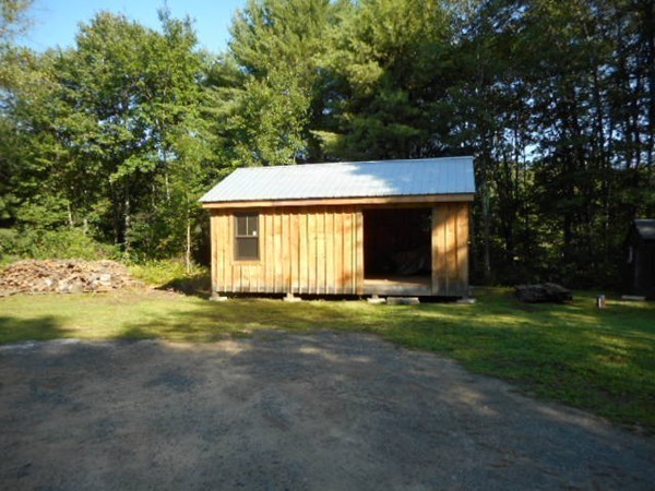 9 Murphy Road North Brookfield, MA 01535 - Photo 16 of 25 a front view of a house with a garden and trees