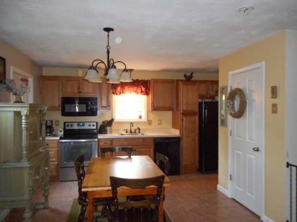 9 Murphy Road North Brookfield, MA 01535 - Photo 3 of 25 a kitchen with refrigerator cabinets dining table and chairs